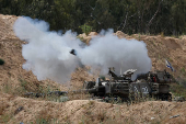 A mobile artillery unit fires towards Gaza, as seen from the Israel