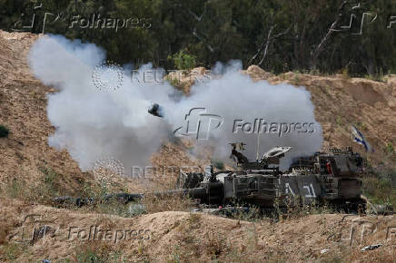 A mobile artillery unit fires towards Gaza, as seen from the Israel