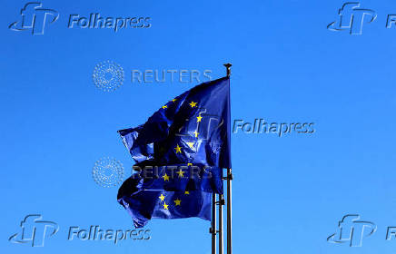 FILE PHOTO: European Union flags flutter outside the EU Commission headquarters in Brussels