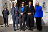 People await a ruling on an appeal by For Women Scotland outside the Supreme Court in London
