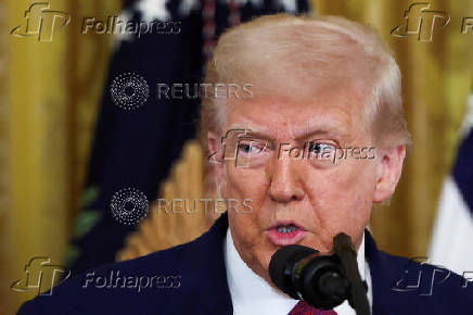 U.S. President Trump signs a resolution at the White House