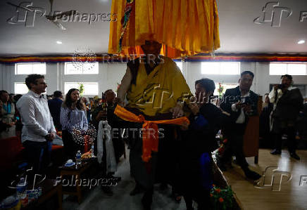 Tibetans mark the 90th birthday celebration of their spiritual leader, the Dalai Lama, at Jawalakhel Handicraft Center in Lalitpur