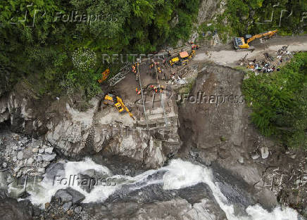 A drone view of BRO and SDRF officials attempting to build a makeshift bridge in Gangnani