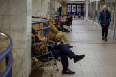 People take shelter inside a metro station during a Russian military strike in Kyiv