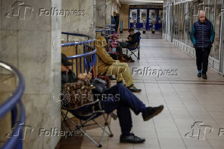 People take shelter inside a metro station during a Russian military strike in Kyiv