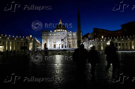People walk at St. Peter's Square, ahead of the conclave, at the Vatican