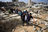 Mourners carry the bodies of members of the Al-Arabeed family killed in Israeli strikes, at a cemetery, in Gaza City