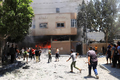 Palestinians search for casualties at the site of an Israeli strike on a house in Gaza City