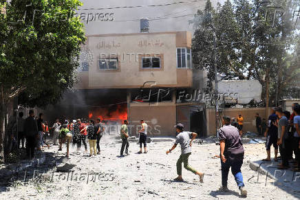 Palestinians search for casualties at the site of an Israeli strike on a house in Gaza City