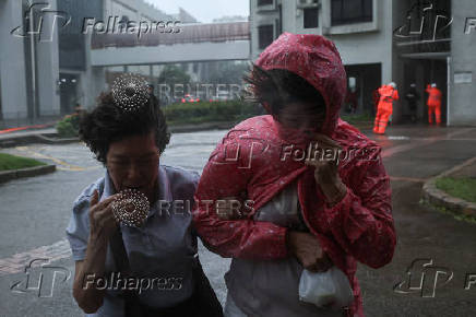 People brave strong winds as Typhoon Wipha approaches, in Hong Kong
