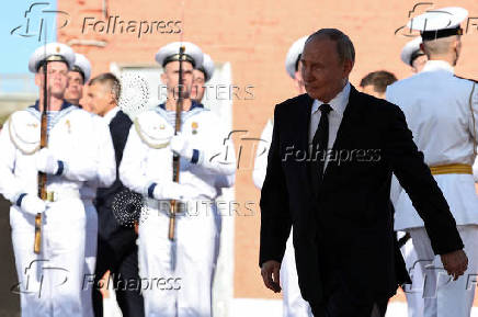 Russian President Vladimir Putin attends a ceremony of raising a naval flag aboard the Knyaz Pozharsky nuclear-powered ballistic missile submarine in Severodvinsk