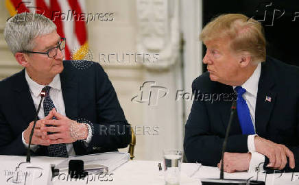 FILE PHOTO: Apple CEO Cook and U.S. President Trump participate in American Workforce Policy Advisory Board meeting at the White House in Washington