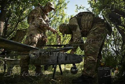 Members of the National Police Special Purpose Battalion prepare an unmanned aerial vehicle for reconnaissance flight on a front line in Zaporizhzhia Region