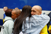 Women embrace Ukrainian prisoners of war as they return after a swap in an undisclosed location in Ukraine