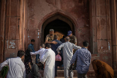 Worshipers enter Badshahi Mosque past security ahead of Eid al-Adha in Lahore