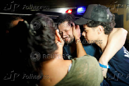 Arturo Suarez, who was held for months in an El Salvador prison, greets family members after his release, in Caracas