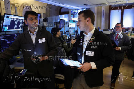 Traders work on the floor at the New York Stock Exchange, in New York City