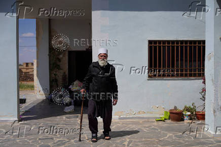A Druze resident of Al-Soura al-Kubra, Salman Olaiwi, inspects his damaged home