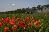 Ukrainian servicemen fire a multiple rocket launcher towards Russian troops on a front line in Zaporizhzhia region