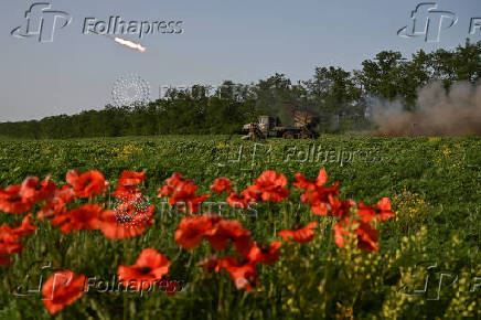 Ukrainian servicemen fire a multiple rocket launcher towards Russian troops on a front line in Zaporizhzhia region
