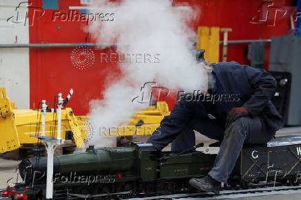 A member of the Ground Level 5 Inch Guage Mainline Association prepares a miniature train during The Greatest Gathering, a railway festival marking 200 years of rail history, at Alstom?s Litchurch Lane factory in Derby