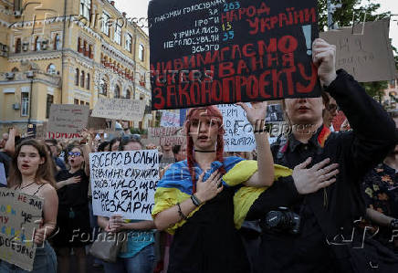 Ukrainians protest against a newly passed law, which curbs independence of anti-corruption institutions in Kyiv