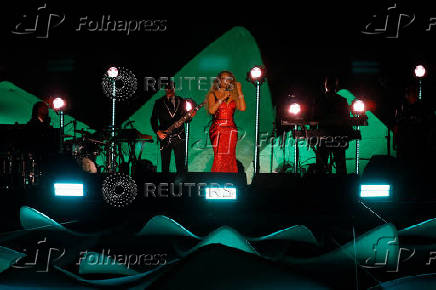 Mariah Carey performs on a floating stage shaped like a giant Victoria amazonica water lily at the Guama River in Belem