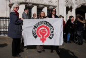 People await a ruling on an appeal by For Women Scotland outside the Supreme Court in London