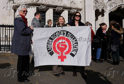 People await a ruling on an appeal by For Women Scotland outside the Supreme Court in London