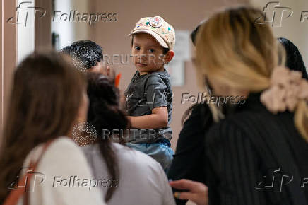 A migrant is detained by federal immigration officers at U.S. immigration court