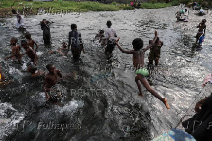 FILE PHOTO: Children cool off at Kihira River in Sake, Masisi territory, which is controlled by M23 rebels, near Goma