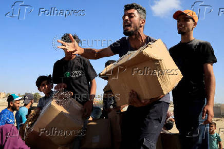 Palestinians seeking aid gather near an aid distribution site run by the U.S.-backed Gaza Humanitarian Foundation, in Rafah
