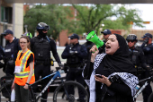 A pro-Palestinian protester demonstrates outside Calgary Municipal Building, on the first day of the G7 Leaders' Summit, in Calgary