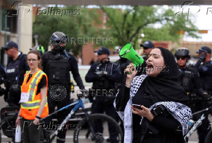 A pro-Palestinian protester demonstrates outside Calgary Municipal Building, on the first day of the G7 Leaders' Summit, in Calgary