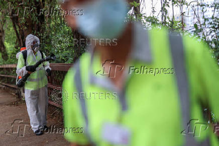 A worker sprays insecticide at a public housing estate following reports of imported cases of Chikungunya in Hong Kong