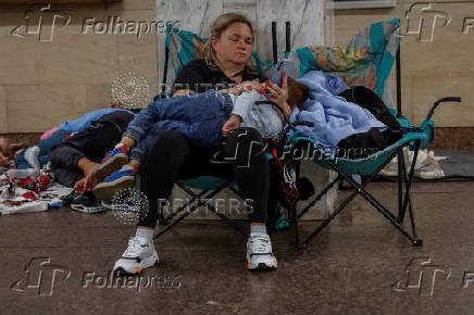 People take shelter inside a metro station during an air raid alert in Kyiv
