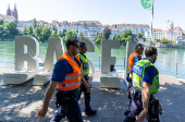 Members of the police patrol along the banks of the Rhine river during the Eurovision Song Contest in Basel