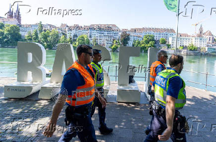 Members of the police patrol along the banks of the Rhine river during the Eurovision Song Contest in Basel