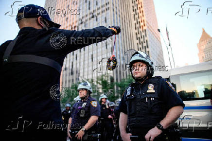 People protest against federal immigration sweeps, next to the U.S. immigration court at the Jacob K. Javits Federal Building, in New York