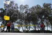 Protestors stand at the entrance to Kibbutz Nir Oz, on the day Israeli PM Netanyahu is expected to visit for the first time since the October 7, 2023 attack