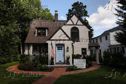 A Nassau County building permit stands in front of a home on the North Shore of Long Island city of Manhasset, New York