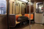 A person sleeps in a subway in New York City