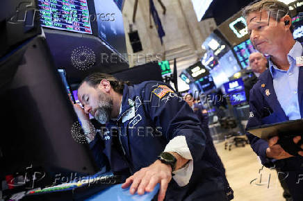 Traders work on the floor at the New York Stock Exchange, in New York City
