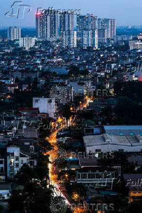 Vehicles travel on a road in Hanoi