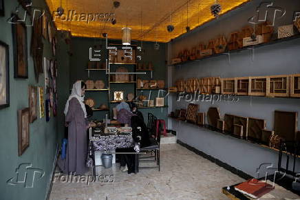 Afghan girl teach Nuristani wood carving skills at a workshop in Kabul