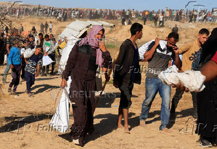 Palestinians receive aid from the U.S.-backed Gaza Humanitarian Foundation, in Khan Younis