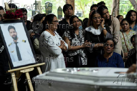 Friends and family members mourn near the coffin of Co-Pilot Clive Kunder, who died after an AIR India Boeing 787-8 Dreamliner plane crashed during take-off from an airport in Ahmedabad, in Mumbai