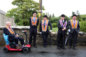 People participate in the Orange Order march along the beach in Rossnowlagh