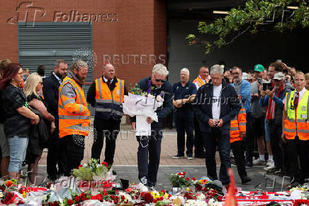 Fans pay their respects outside Anfield Stadium, on the day of the funeral of Liverpool soccer player Diogo Jota in Portugal, in Liverpool