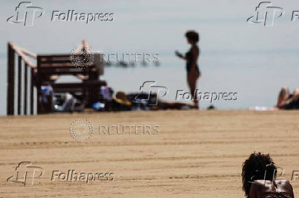 A woman sunbathes during a heatwave in the Bronx borough of New York City